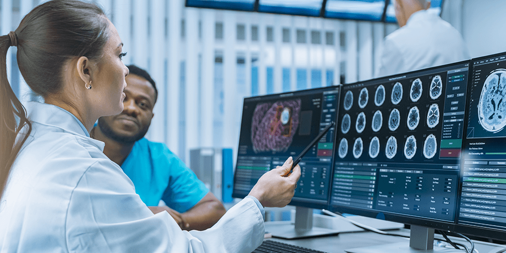 Clinicians viewing patient data on a computer screen